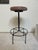 360 swivel barstool made of wrought-iron and leather. In good vintage condition. Wear commensurate with age and use....