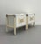 A striking pair of vintage postmodern bedside tables featuring a crisp white lacquered finish accented by faux bamboo...