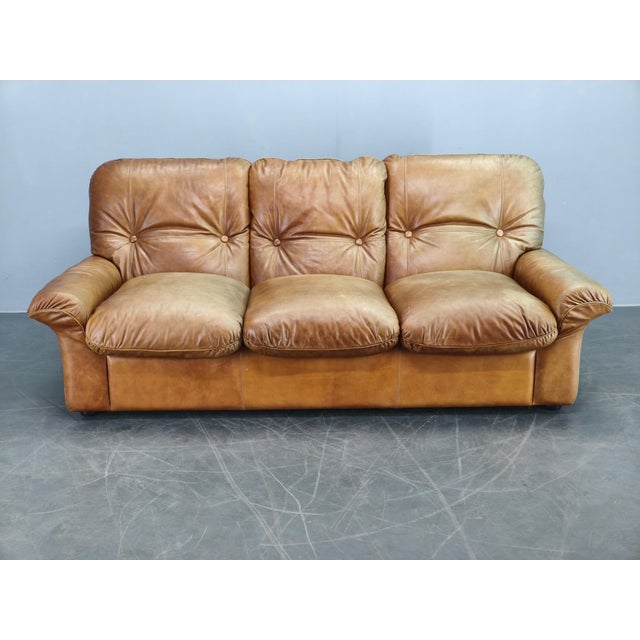 Large and comfortable 3-seater sofa produced by Arcon Italia in the 1970s. Crafted from high-quality cognac buffalo...