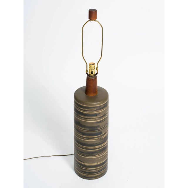 Tall Martz ceramic lamp with teak neck and finial. Height is to the top of the socket.