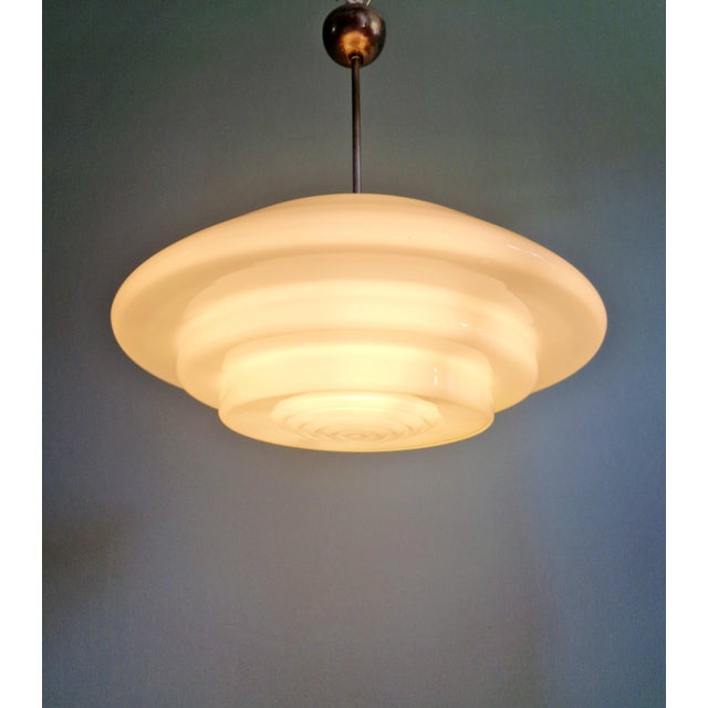 Xxl bauhaus pendant light (50 cm diameter) in white opaline glass, 1930s. brass frame with a patina acquired over time....