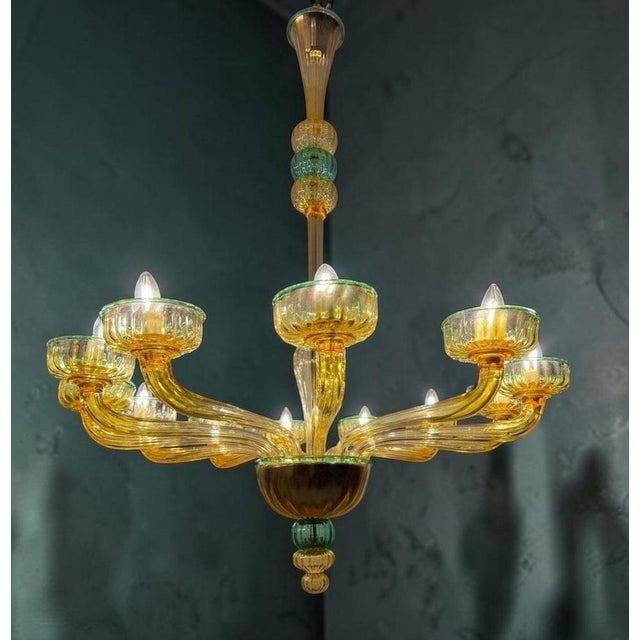 This magnificent amber color chandelier features 12 arms with emerald color finishes. Cleaned and re-wired, in full...