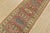 A tribal Caucasian Kazak runner hand-knotted with fine wool on a cotton foundation. This rug features geometric floral...