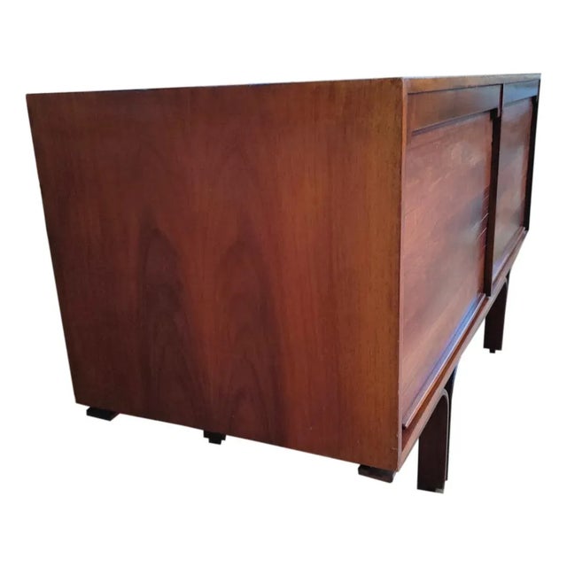 rosewood sideboard produced by Bernini, design gianfranco Frattini, 1957. Composed of two compartments closed by a...