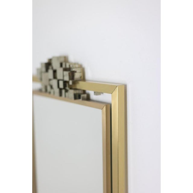 “Boizot” model mirror, in brass, satin varnish finish and pyrite in the upper part, with graphic decoration. Contemporary...