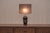 Elegant French table lamp from the 1970s, featuring a black glazed ceramic base with subtle Chinese-inspired influences....