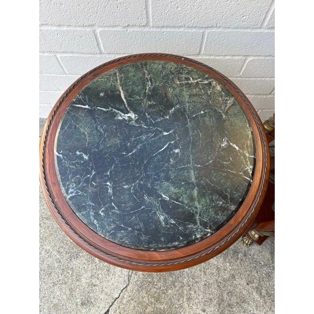 Empire style gueridon side tables with a green marble top and brass mounts. Handmade. No makers mark. Marble tops can be...