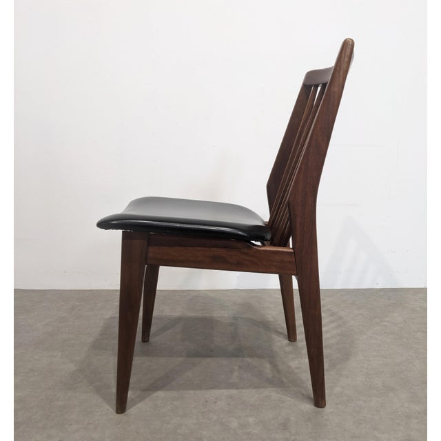 Set of four vintage chairs with black faux leather seats. Very sturdy teak frame.