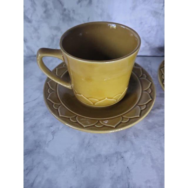 Set-4 pieces. 1980s stoneware coffee mugs and saucers made in the USA. These are in traditional vintage colors with a...