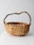 This is a vintage wicker buttocks or melon basket. The handcrafted basket features a rustic wooden branch handle. Classic...