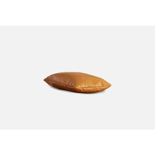 Cognac leather level pillow by msds studio materials: camo leather, fabric dimensions: d 23.5 x w 67 x h 8.5 cm the...