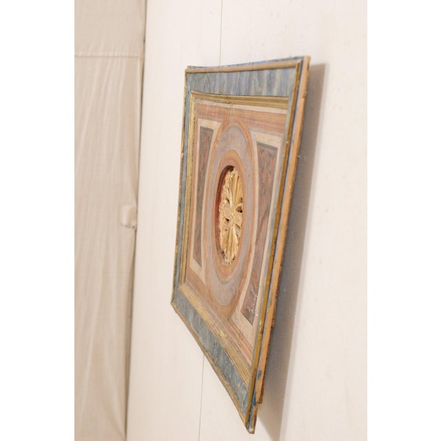 An Italian decorative wall plaque with trapezoid shape from the 19th century. This antique wall ornament from Italy has an...