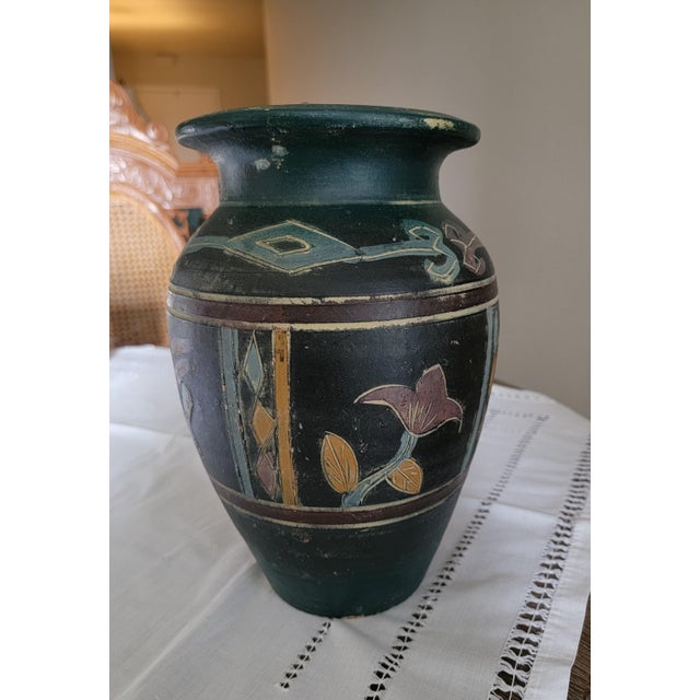 This rustic dark gray/black matte and green (top part) pottery vase features a design often reminiscent of Southwestern or...