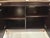 Elegant Caracole Signature Hightower Bookcase. Suede interior, with 3 shelves on top. Dark brown wood. Gold accents....