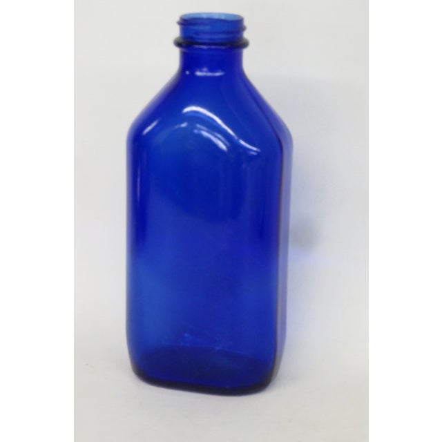 This stunning Medicine Bottle was made by Philips for Milk of Magnesia. Presenting a vibrant cobalt blue color, this...