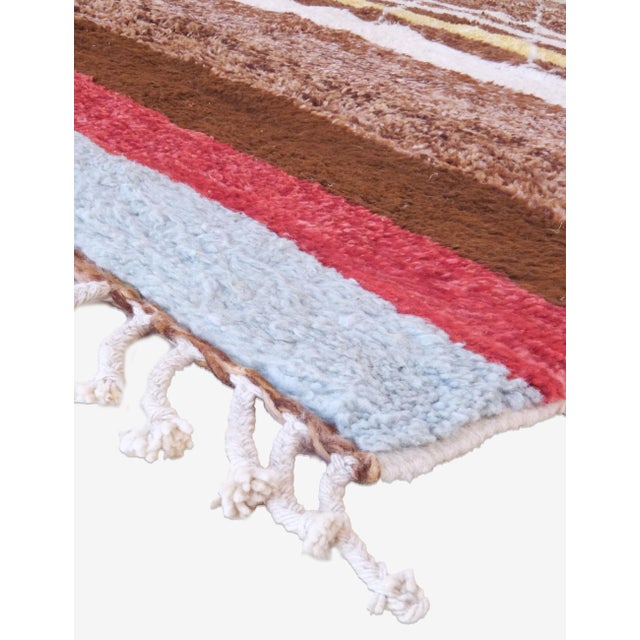 Discover the warmth and charm of this authentic tribal Moroccan wool rug, crafted from organic sheep wool living in the...