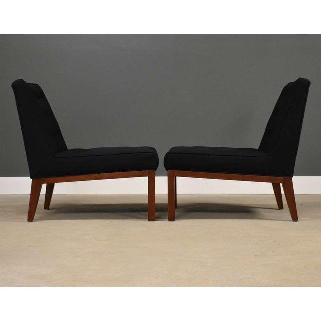 A pair of mid century modern slipper lounge chairs with walnut bases designed by Edward Wormley for Dunbar. Circa 1950’s....