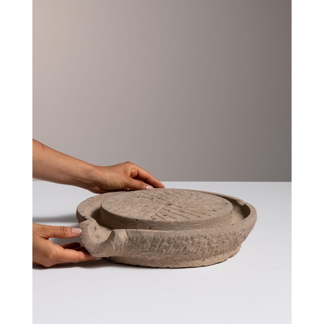 This 19th century pedestal from an unrecorded origin is finished in tan, worked in sandstone. Its form follows honest,...