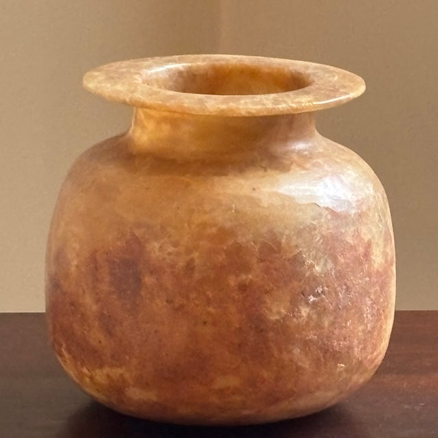 Offering a lovely, handcrafted alabaster vase from Egypt. Love the oviod shape, warm amber tones, and dramatic veining. It...