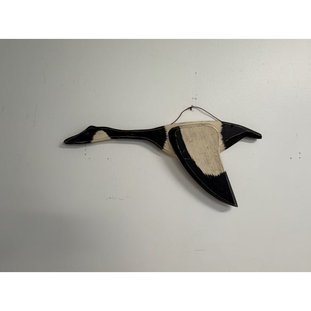 Handmade folk art goose wall sculpture with black and cream painted finish. Carved and shaped in a flying form with...