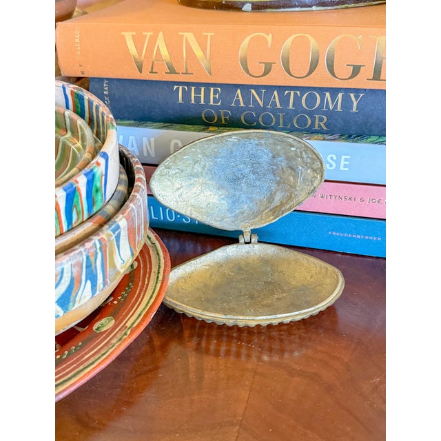 Charming little vintage brass clam shell box with lovely texture throughout. It opens on a single hinge. Store your little...