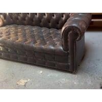 Chesterfield leather sofa with tons of patina and expected wear. Sofa is on 4 small wheels which allows for easy turning...