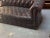 Chesterfield leather sofa with tons of patina and expected wear. Sofa is on 4 small wheels which allows for easy turning...