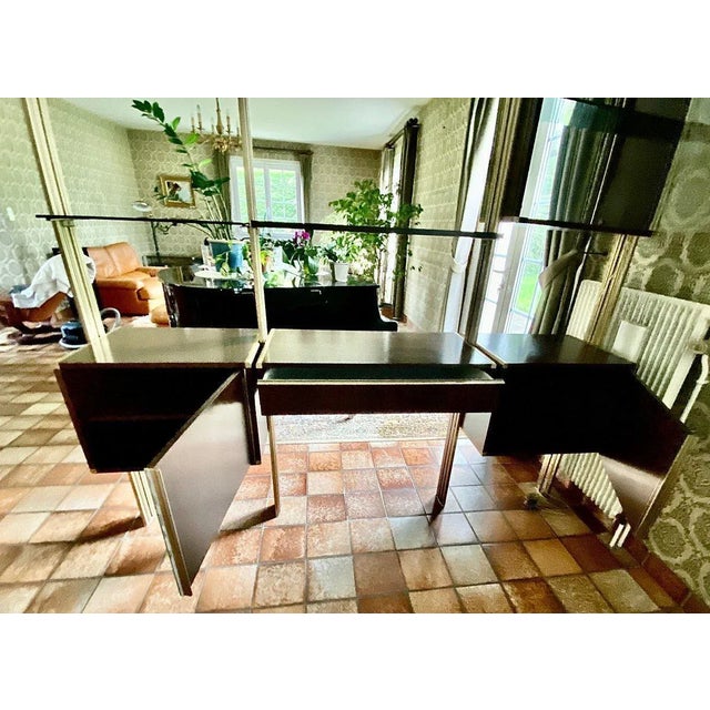 “library” ligne roset. Modular bookcase with four aluminum uprights, floor and ceiling mounting, including: four glass...