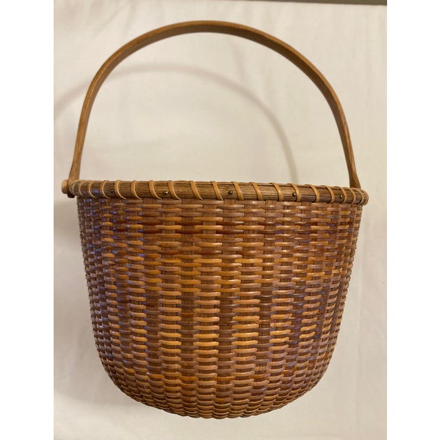 This basket represents the Nantucket Lightship style and is a unique piece from the 1990s, making it a valuable addition...