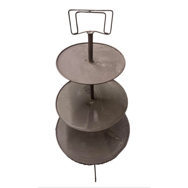 Bring classic charm and vertical organization to your plant collection with this vintage three-tier metal display stand....