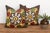 A stylized floral medallion anchors the center of each pillow in this well-matched pair — radiating mustard-gold tulip...