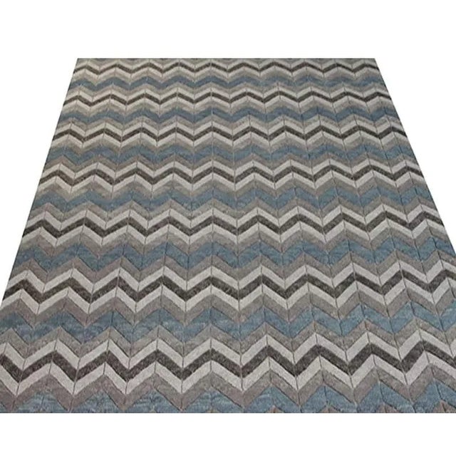 ACTUAL SIZE: 8’5″ x 10’0″ PRIMARY COLOR: Blue / Gray AGE: New ORIGIN: India MATERIALS: Wool FOUNDATION: Cotton PRODUCTION:...