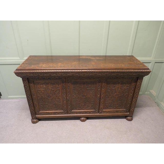 Gothic Carved Golden Oak 3 Door Cupboard This is a long carved country style Oak cupboard, the cupboard has 3 doors...