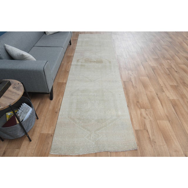 Vintage Hand-Knotted runner rug is a semi-antique vintage area rug. The '70s Eastern region of Anatolia's unique rug is...