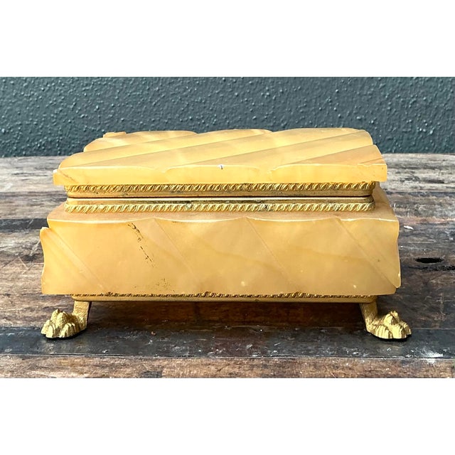 This stunning vintage jewelry box is a masterclass in Hollywood Regency glamour, offering a sophisticated blend of natural...