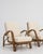 A pair of 20th century armchairs designed in the faux bamboo style, featuring wooden frames carved to imitate bamboo. The...