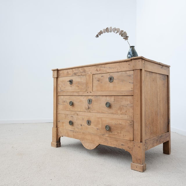A beautiful antique 19th-century chest of drawers, crafted from walnut and cherry wood, with fir side panels. It features...