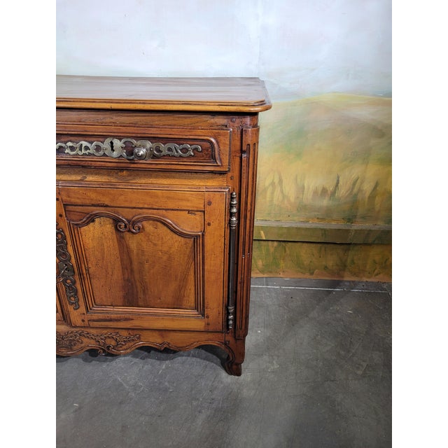 A louis xv period two-part low buffet in walnut. this charming louis xv period low buffet dates from the 18th century. The...
