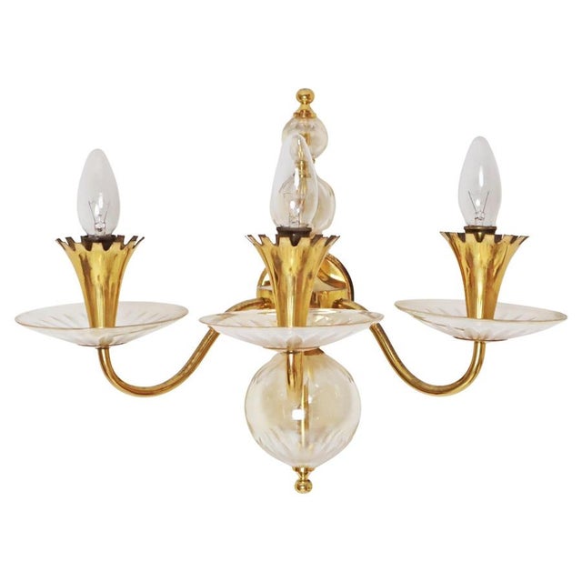 This large, three-armed wall light is simple yet elegant. The design of this sconce is exceptional, and great care was...