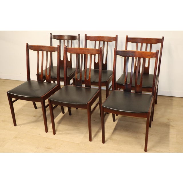Set of six Scandinavian rosewood chairs with an elegant and balanced design. The openwork backs with vertical lines add...