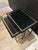 Offered is a vintage set of Hollywood regency style nesting tables by Design Institute of America. This regal set is all...