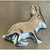 This vintage Mexican sterling silver bunny rabbit brooch captures a crouching hare in a naturalistic, sculptural pose,...