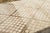 Hand-knotted in wool and originating circa 1950-1959, this 6x10 vintage Moroccan berber rug joins Rug & Kilim’s Moroccan...