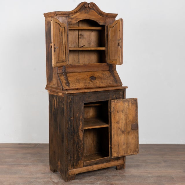19th-century small rustic cabinet from Hungary crafted in pine. Residual original paint remains visible along the base,...