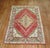 Early 20th-century Turkish Oushak rug with a medallion and border pattern on a red field Measures: 5'7" x 7'9".