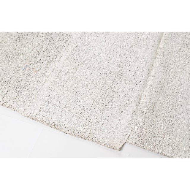 This is a vintage Turkish Oushak rug from the Mid 20th Century. The piece was hand-knotted.