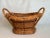 This attractive wicker basket was made using the over and under technique with bentwood handles and wood beaded trim. The...
