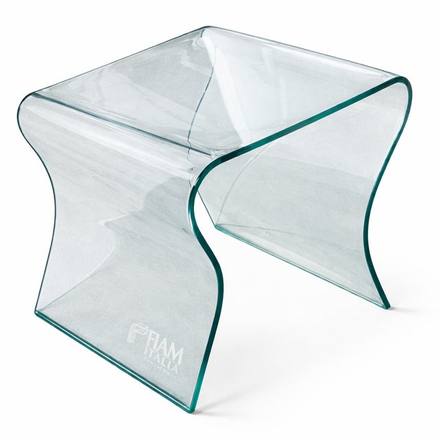 A sculptural curved glass side table by Fiam Italia, designed by Prospero Rasulo. The “Charlotte de Nuit” is crafted from...