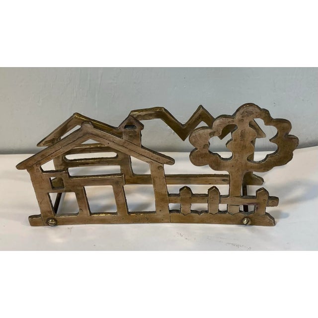 Cute vintage brass napkin holder in the shape of a house and tree.