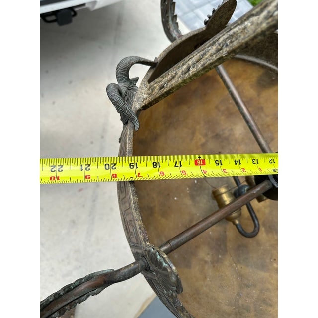 The Maitland-Smith Penn Shell Bronze Chandelier with Rams Heads is a traditional style ceiling fixture that adds a touch...